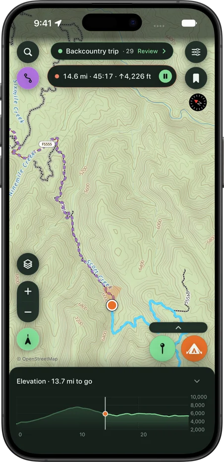 SK Maps following a route while recording the ride: the location dot on the line among contours and forest roads, with distance, time and climb in the pill at the top